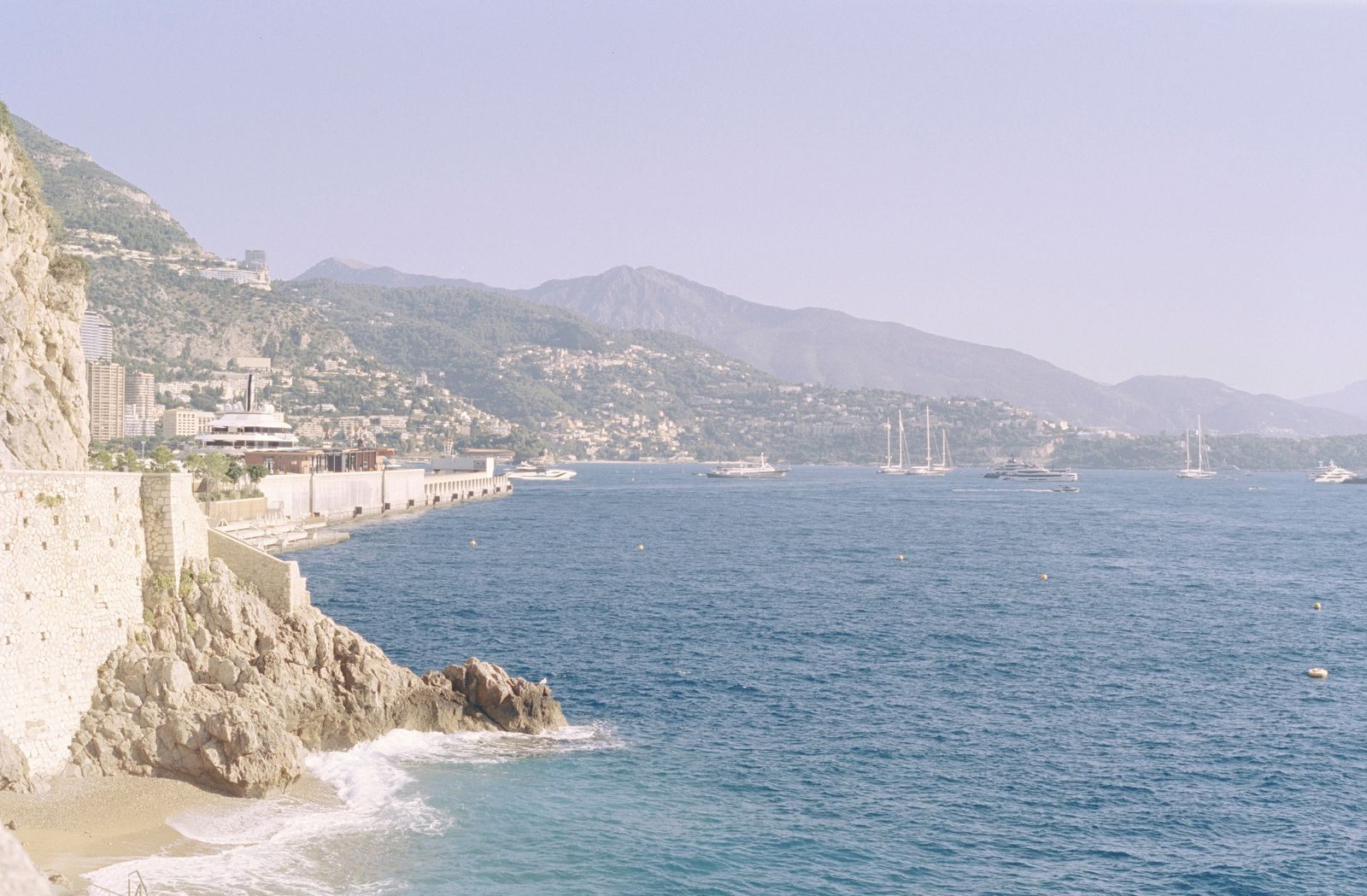 The Monaco coastline, yachts and mountains on the French Riviera