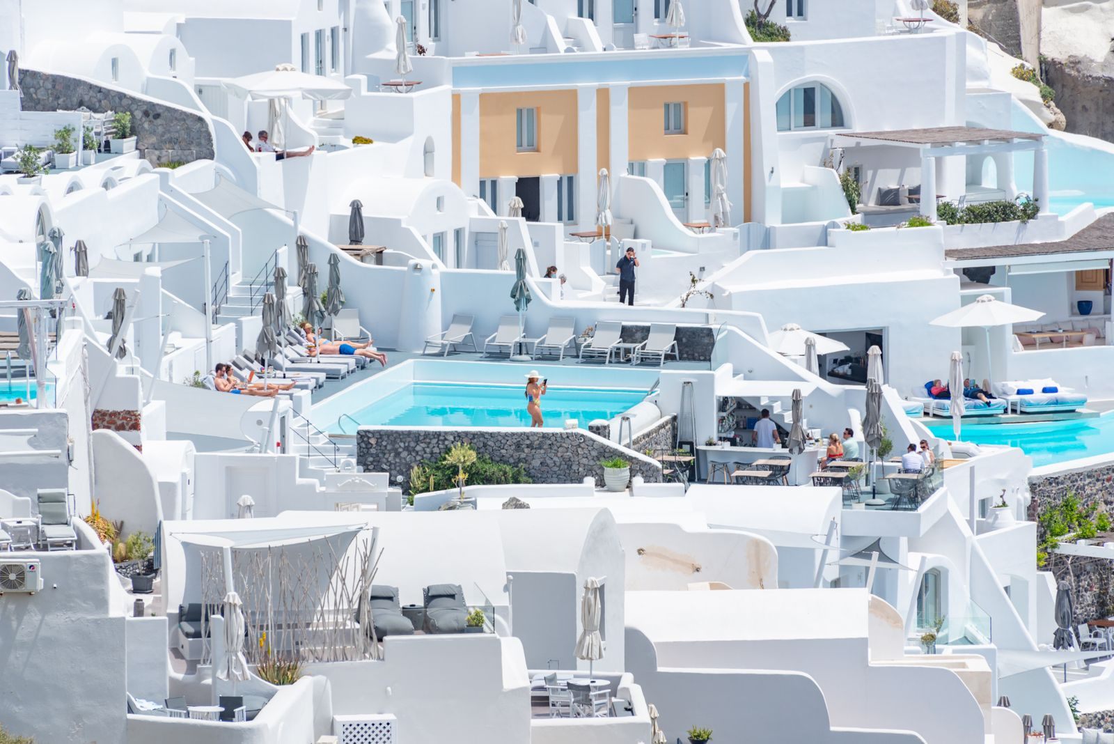White cave-style suites with plunge pools in Santorini